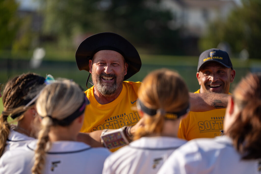 Coach Roger Dufour celebrating with team after 400 wins