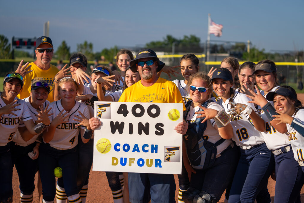 Coach Roger Dufour celebrates with team after win