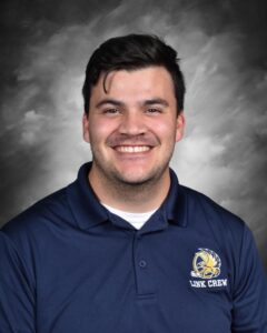 Smiling individual wearing a navy blue polo shirt with a "Link Crew" logo, set against a gray background.